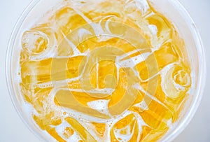 Beer with ices in glass on the white table.Glass of beer on white table in Golden Light.