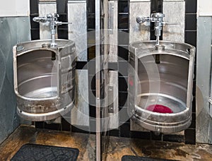Beer keg urinals in men`s room
