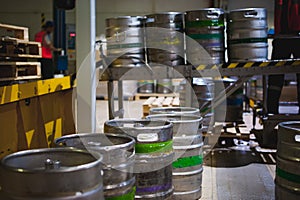 Beer kegs. many metal beer keg stand in rows in a warehouse