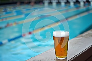 beer on ledge, swim meet in stadium pool