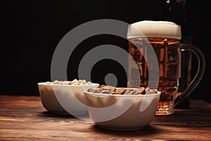 Beer light in a mug and snack