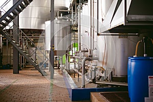 Beer manufacture line. Equipment for staged production bottling of Finished food products. Metal structures, pipes and tanks at en