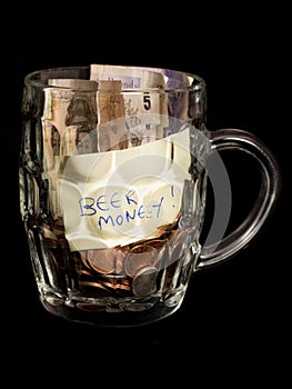 Beer money savings in a pint glass