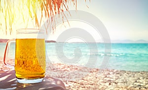 Beer in mug on beach