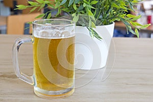 Beer mug filled with fresh draught beer on a table