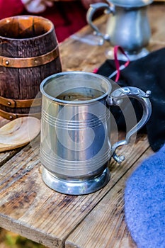 Beer mug tin ceramic barrel close-up wooden table pub traditional dishes