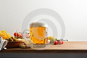 Beer mug on wooden bench and snacks white isolated background