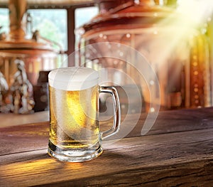 Beer mug on wooden table and copper brewing cask at the background