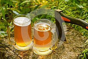 Beer mugs cheers on natural background