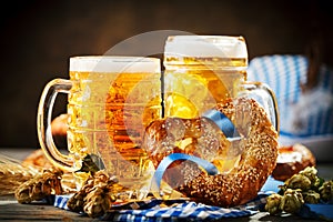 Beer mugs and pretzels on a wooden table. Oktoberfest. Beer festival.