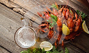 Beer party. Still life with glass of beer, crayfish crawfish against old wooden rustic background. Top view. Overhead. Copy space