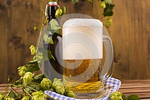 Beer. Pint of Beer close up on a wooden background. Cold Craft light Beer in a glass with water drops. Beer is pouring