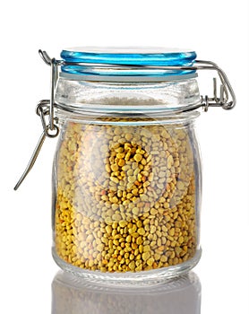 A beer pollen in a glass jar is on a white background. Natural remedy for immunity enhancement. Beekeeping