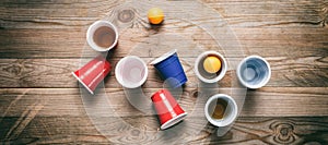 Beer pong. Plastic red and blue color cups and ping pong balls on wood, banner