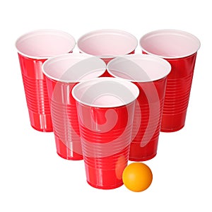 Beer pong. Red plastic cups and orange ping-pong ball isolated on white. Closeup