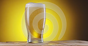 Beer is poured into a glass of beer, creating many bubbles.