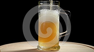 Beer is poured into a glass goblet. Slow motion