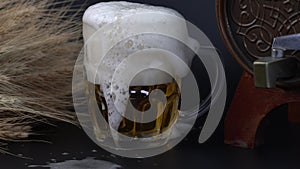 Beer is pouring into a mug. Beer forming waves close up.