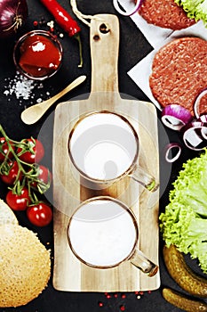 Beer and Raw Ground beef meat Burger steak cutlets with seasoning and vegetables