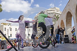 Beer-Sheva, ISRAEL - March 5, 2015:Boys and girls performed on bicycles with one wheel on the street scene - Purim