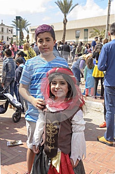 Beer-Sheva, ISRAEL - March 5, 2015: Teenager boy with purple hair dyed in a blue striped shirt with girl -Purim