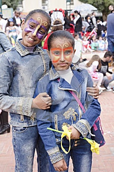 Beer-Sheva, ISRAEL - March 5, 2015: Two dark-skinned teen girl in denim dress with butterflies makeup on their faces - Purim