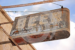 A beer sign marks the location of a long abandoned bar.