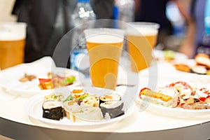 Beer and small buffet bites in plates on table food and drink concept