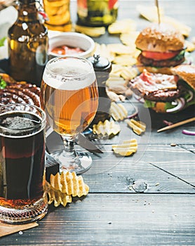 Beer and snack variety on dark wooden scorched background