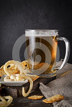 Beer with snacks ,  glass of light beer with onion rings and sauce