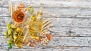 Beer and snacks. Salted crackers, Dried Fish, Chips, Nuts, Peanuts, Pistachios. On a white wooden background.