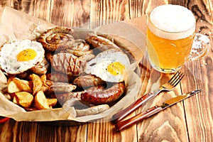 Beer snacks set on wooden background top view with beer in glass closeup and copy space