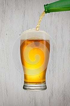 Beer splash in glass on vintage background