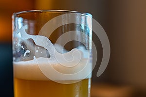 Beer in Tall Glass close-up shot in Bar