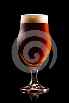 Beer in a tall glass on a dark black background. Mugs with drink like Ipa, Pale Ale, Pilsner, Porter or Stout