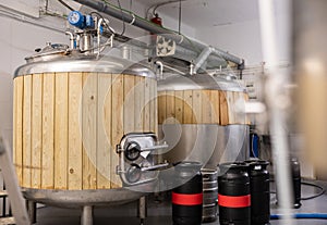 Beer tanks and barrels in brewery