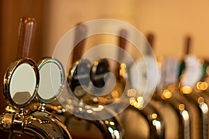 The beer taps in a pub with different kinde of craft beer