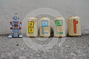 Beer text painted over beer cans with a tin toy robot