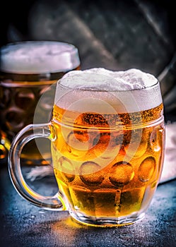 Beer. Two cold beers. Draft beer. Draft ale. Golden beer. Golden ale. Two gold beer with froth on top. Draft cold beer in glass.