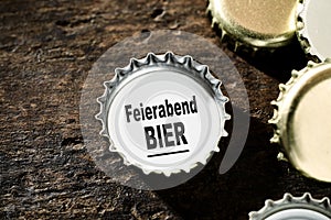 Beer after work concept with bottle tops photo