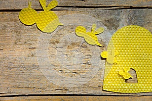 Beeswax, bees and a beehive on wooden table