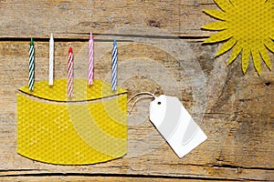 Beeswax, cake with candles and sun on wooden table, empty sign