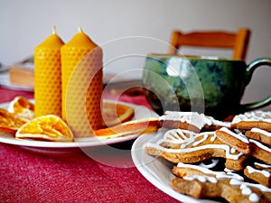 Beeswax candles, dried oranges and gingerbread photo