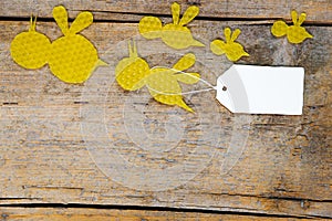 Beeswax, flying bees on wooden table, empty note