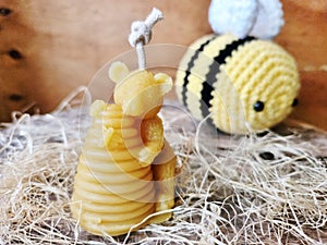 Beeswax handmade candle. Bear with honey beehive.