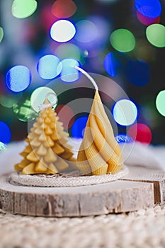 Beeswax spruce shaped candles on dark background