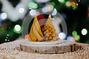 Beeswax spruce shaped candles on dark background