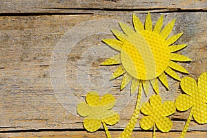 Beeswax, sunflowers on wooden table, copyspace