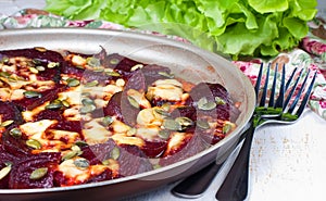 Beet baked in the oven with cheese and pumpkin seeds