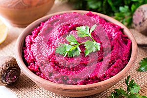 Beet hummus, creamy and delicious in a ceramic bowl